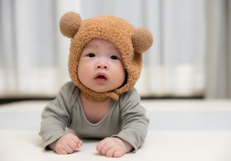 Infant boy with cute fluffy bear style hat